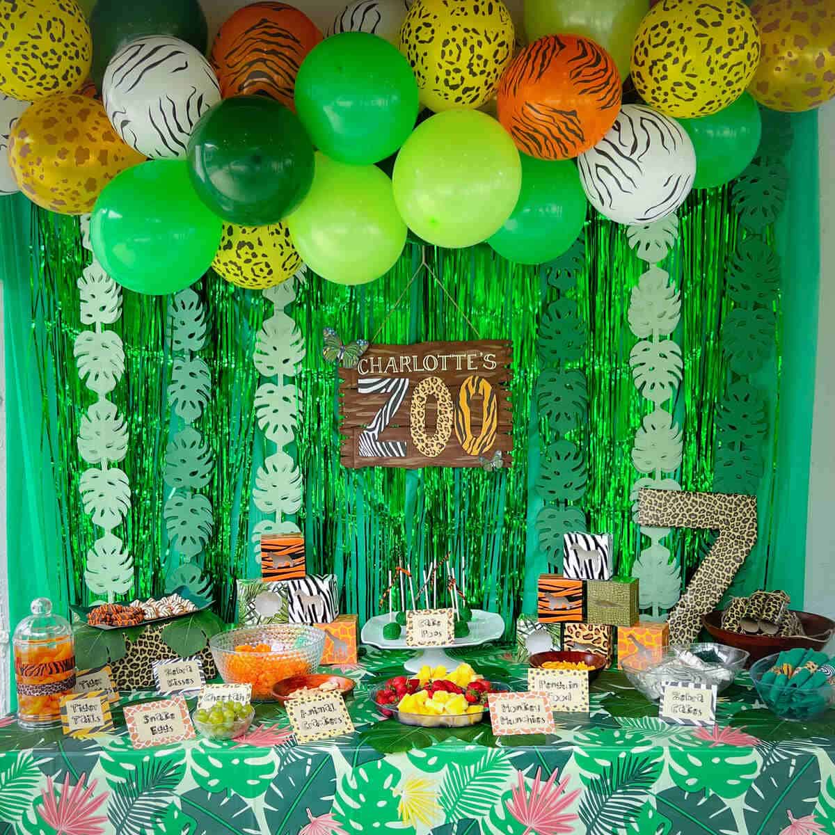 a dessert table and backdrop for a Zoo Birthday Party