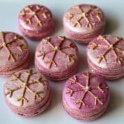 Nut Free Raspberry Truffle Macarons with gold snowflakes on top