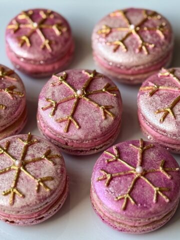 Nut Free Raspberry Truffle Macarons with gold snowflakes on top