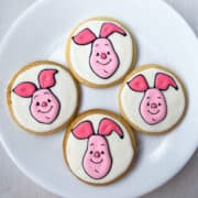 Piglet Sugar Cookies with royal icing on a white plate