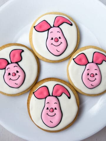 Piglet Sugar Cookies with royal icing on a white plate
