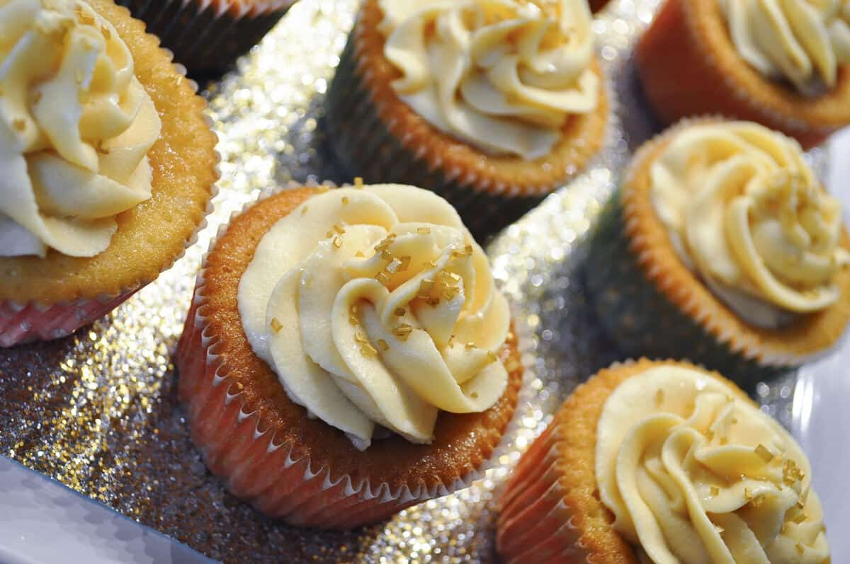 tres leches cupcakes on a sparkly gold platter