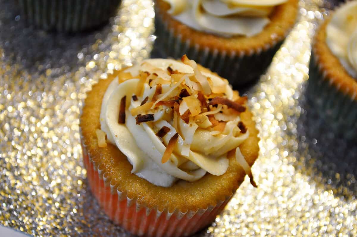 Tres Leches Coconut Cupcakes with Dulce de Leche Buttercream on a sparkly gold platter