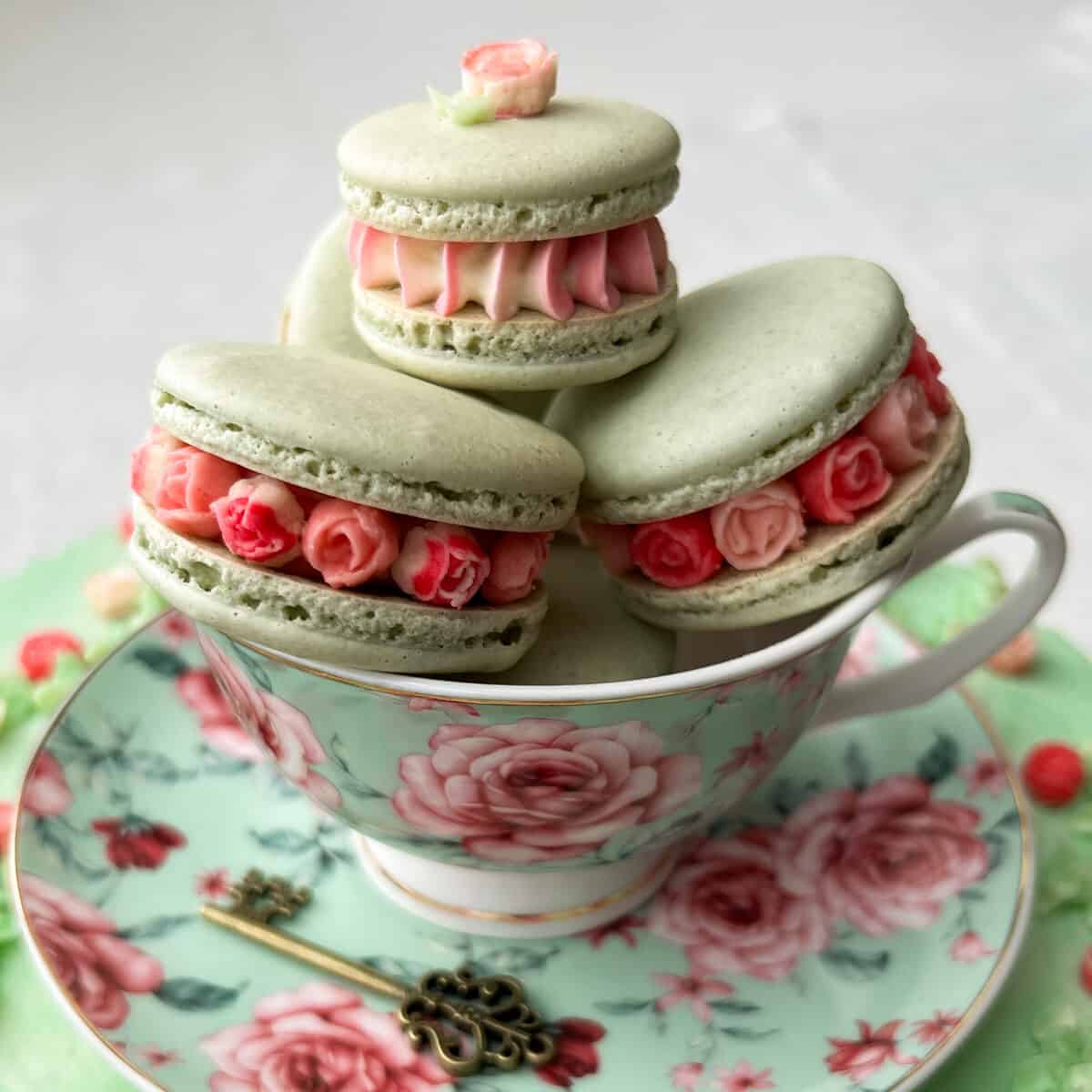 Mini Rose French Macarons in a tea cup on a saucer