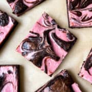 Raspberry Cheesecake Brownies on brown parchment paper