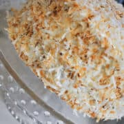 Toasted Coconut Cake on a glass cake stand