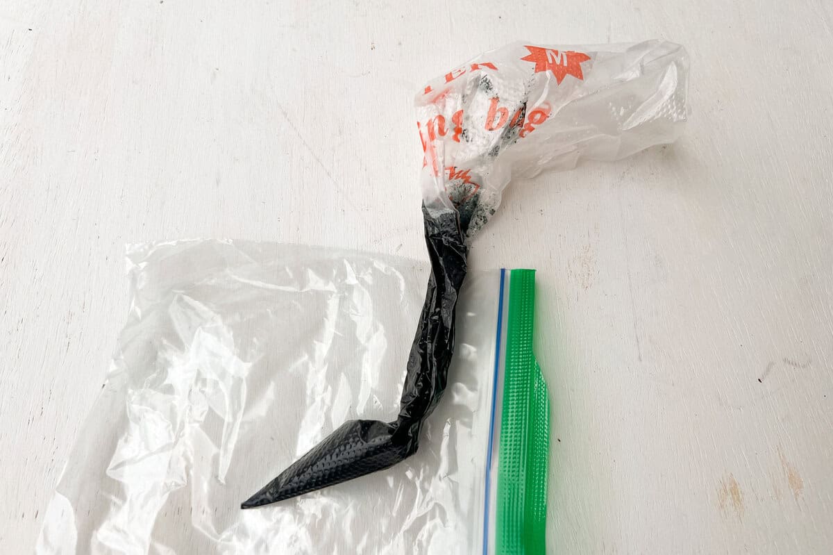 disposable piping bag with black royal icing inside