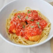 a bowl of spaghetti and healthy baked chicken meatballs covered in marinara sauce