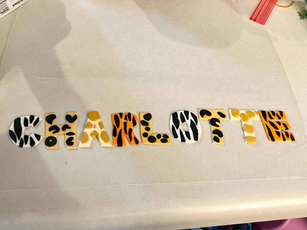 rolled fondant safari print letters spelling "Charlotte"