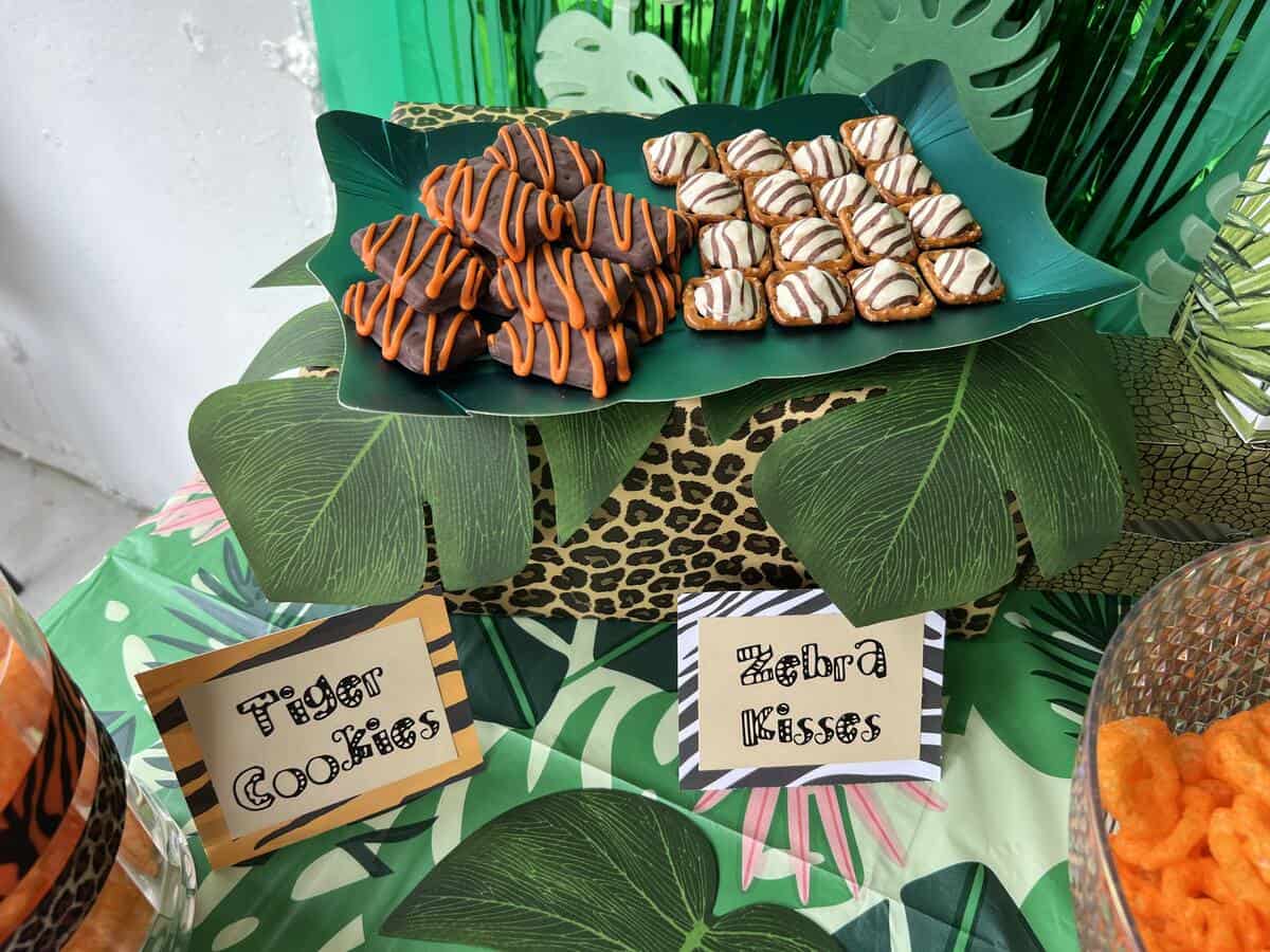 zoo themed treats on a leopard print wrapped box with faux leaves