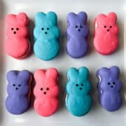 Nut Free Bunny Peep Macarons in a pink, blue and purple on a square white plate