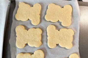 teddy bear shaped sugar cookies on parchment paper