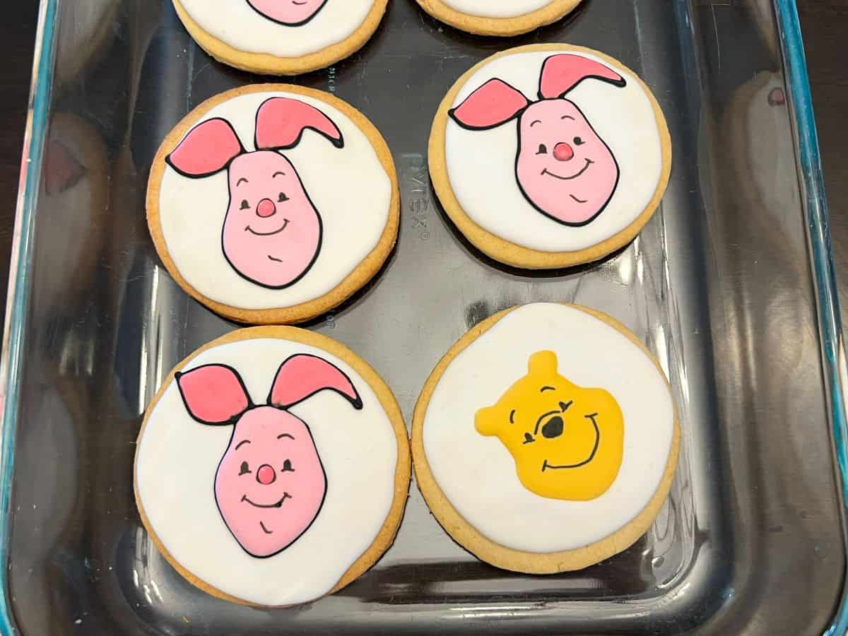 Winnie the Pooh and Piglet sugar cookies in a glass dish