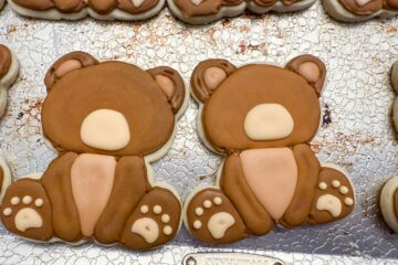teddy bear cookies with the snout and paws piped on before the face has been added