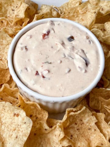 Harry & David Pepper & Onion Relish Dip in a white ramekin with Tostitos scoops around it