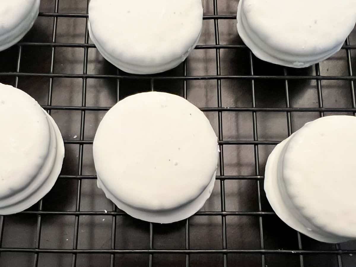 white fudge covered Oreos on a wire rack
