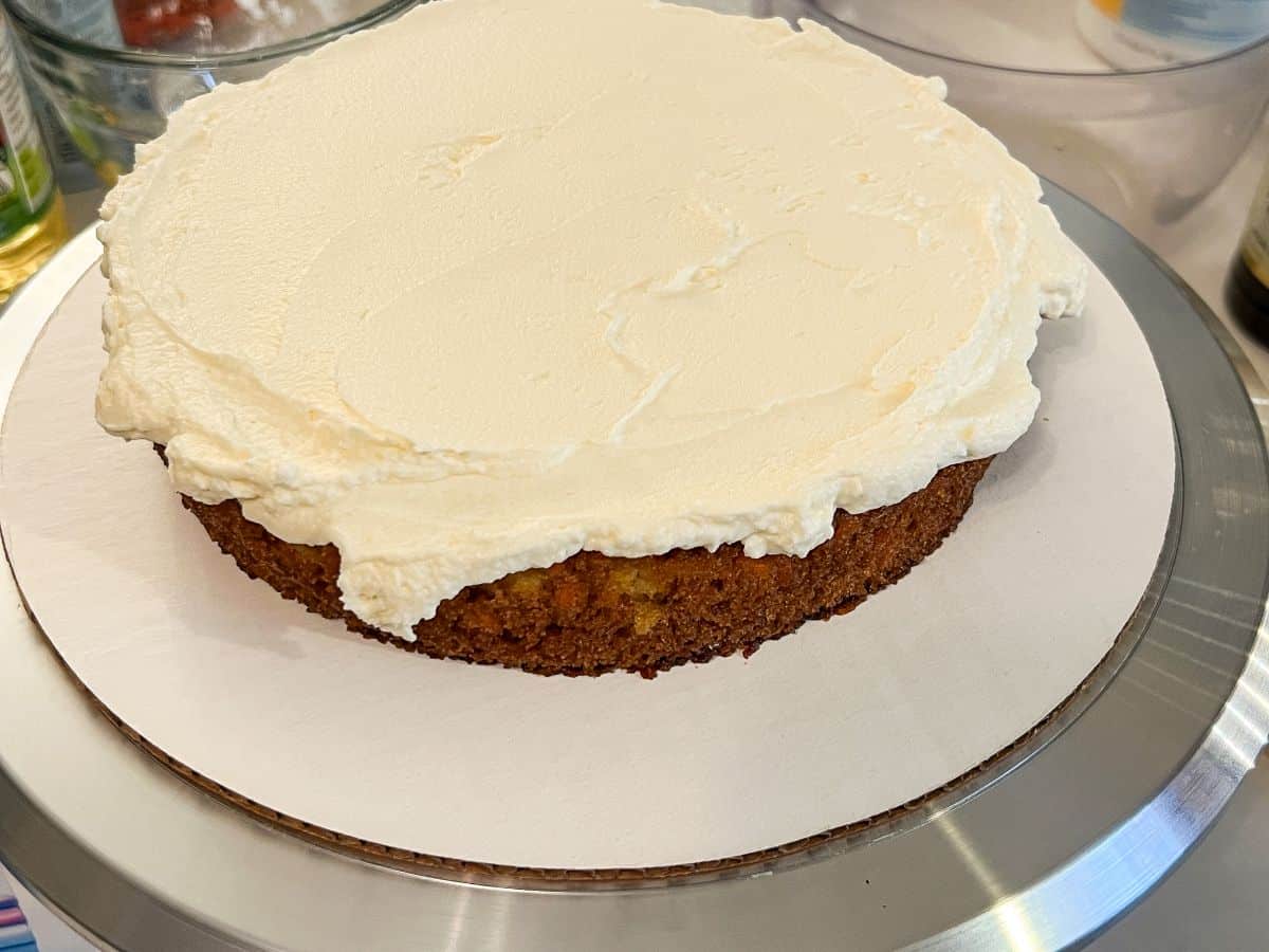 a single layer of carrot cake with a layer of cream cheese frosting on top