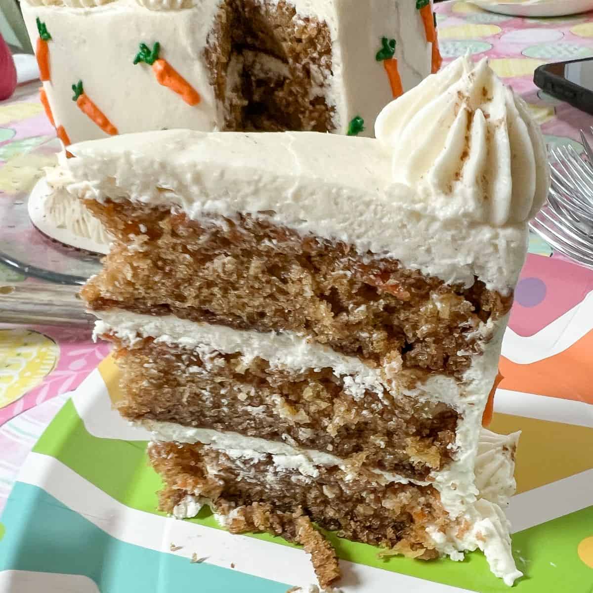 a slice of carrot cake on a colorful paper plate