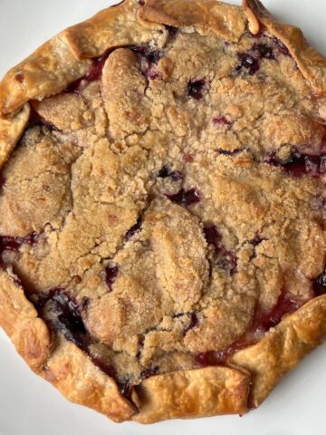 Blueberry Peach Rustic Tart on a white cake platter