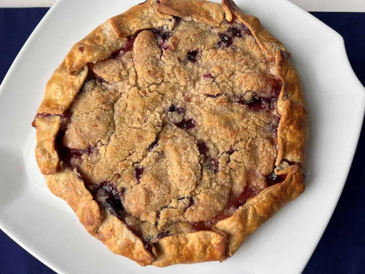 Blueberry Peach Rustic Tart on a white cake platter