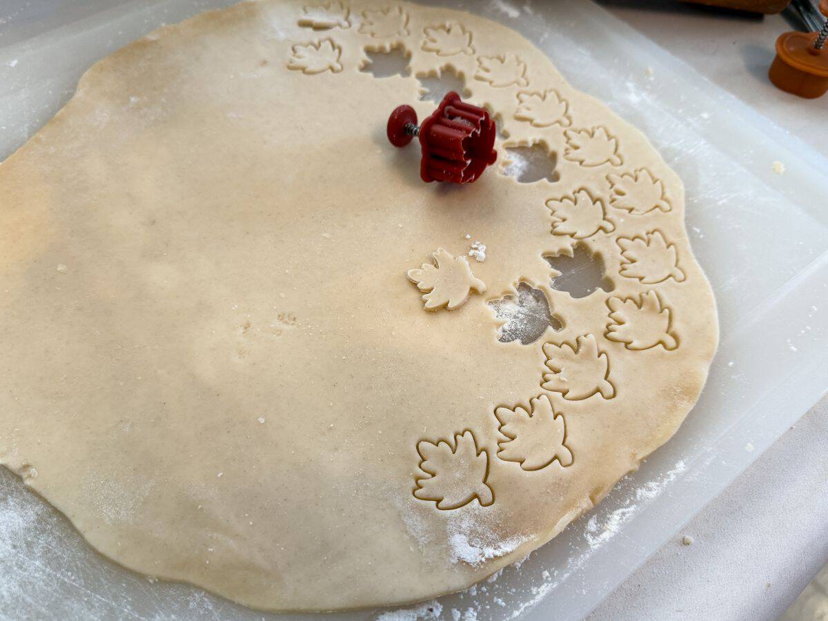 pie dough rolled thin and cut with some leaf shapes