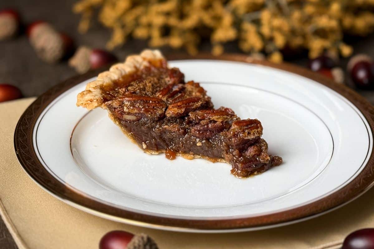 a slice of Famous Pecan Pie on a white china plate