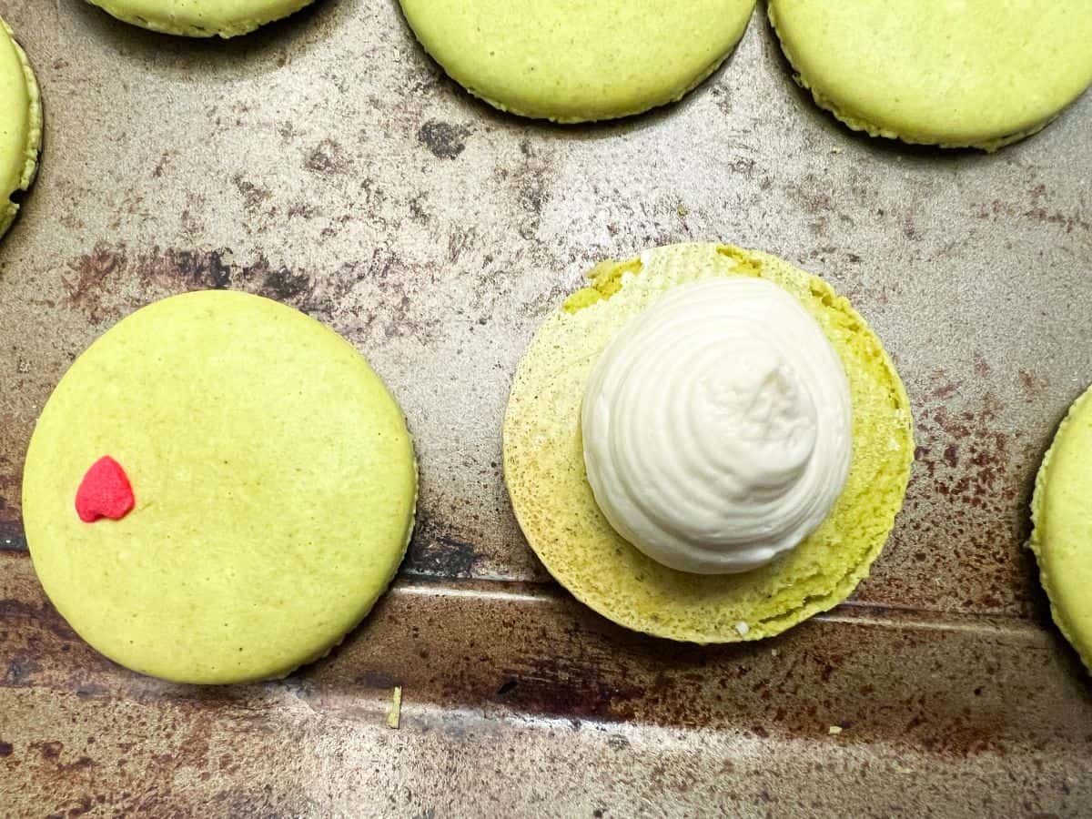 vanilla buttercream piped on a macaron shell