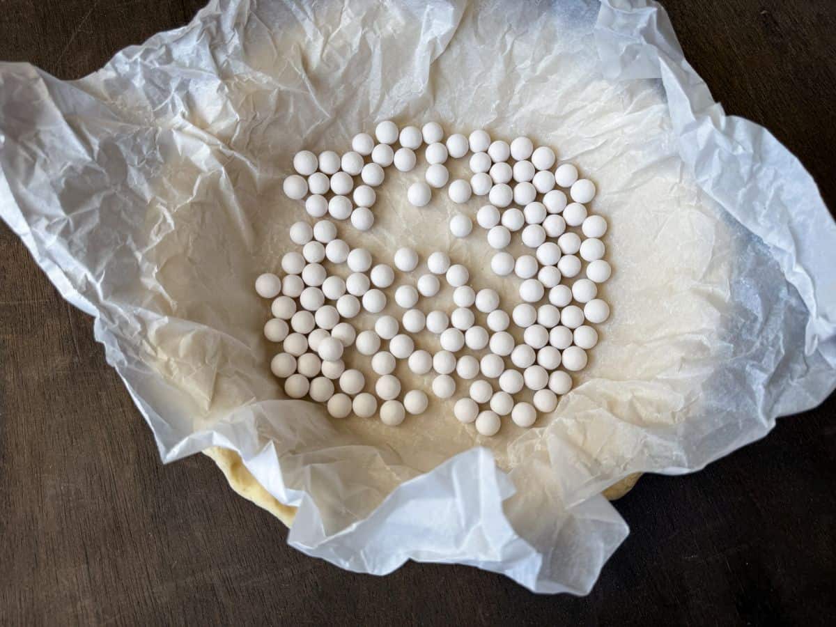 a pie plate lined with parchment paper and filled with pie plates