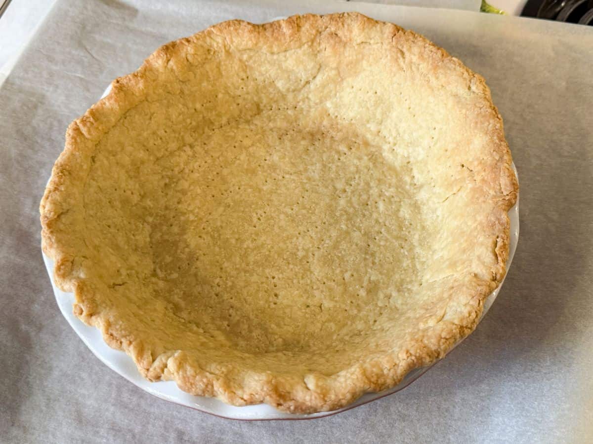 a single crust pie in a pie plate that has been par-baked