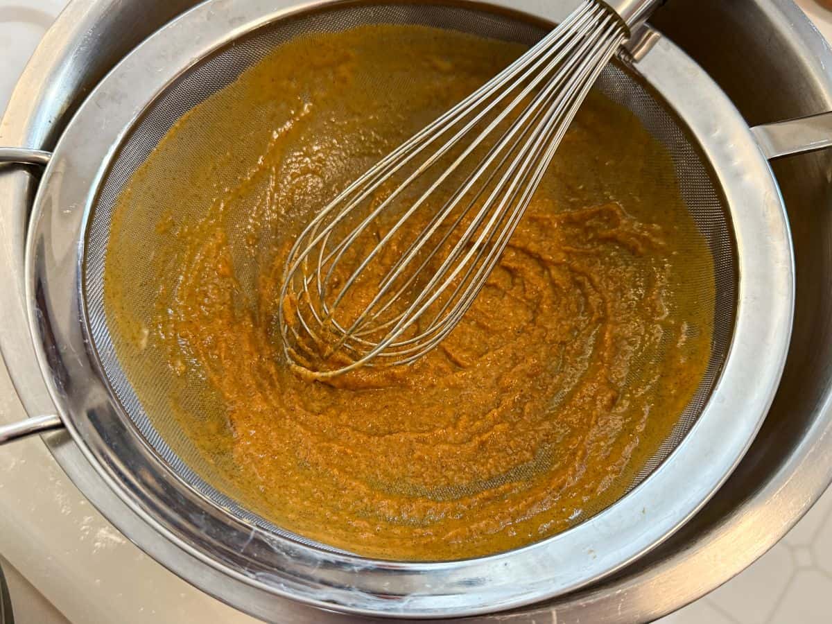 pumpkin pulp remaining in a fine mesh sieve after pumpkin pie filling has been strained