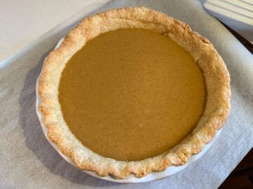 pumpkin pie filling poured into a par-baked single crust before baking the custard