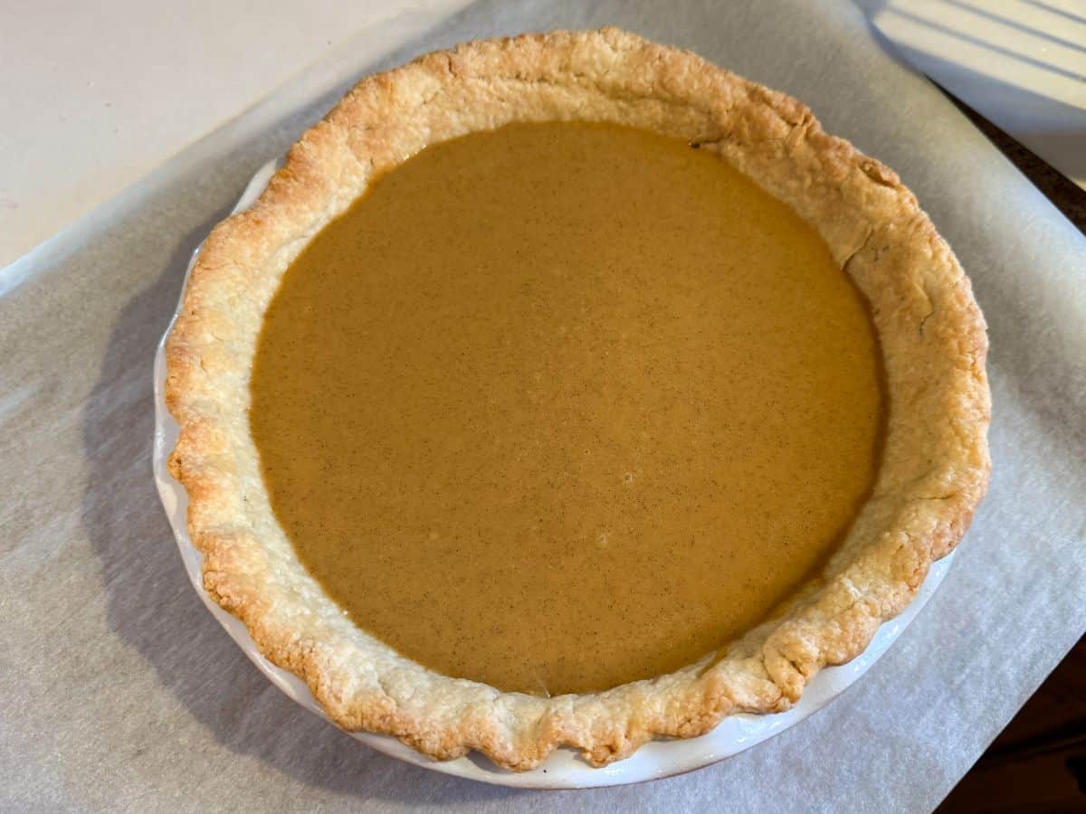 pumpkin pie filling poured into a par-baked single crust before baking the custard