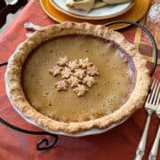 an all butter pie dough single crust pumpkin pie on a Thanksgiving table