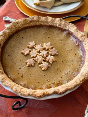 an all butter pie dough single crust pumpkin pie on a Thanksgiving table