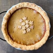 a pumpkin pie with cinnamon sugar leaf shapes on top to decorate