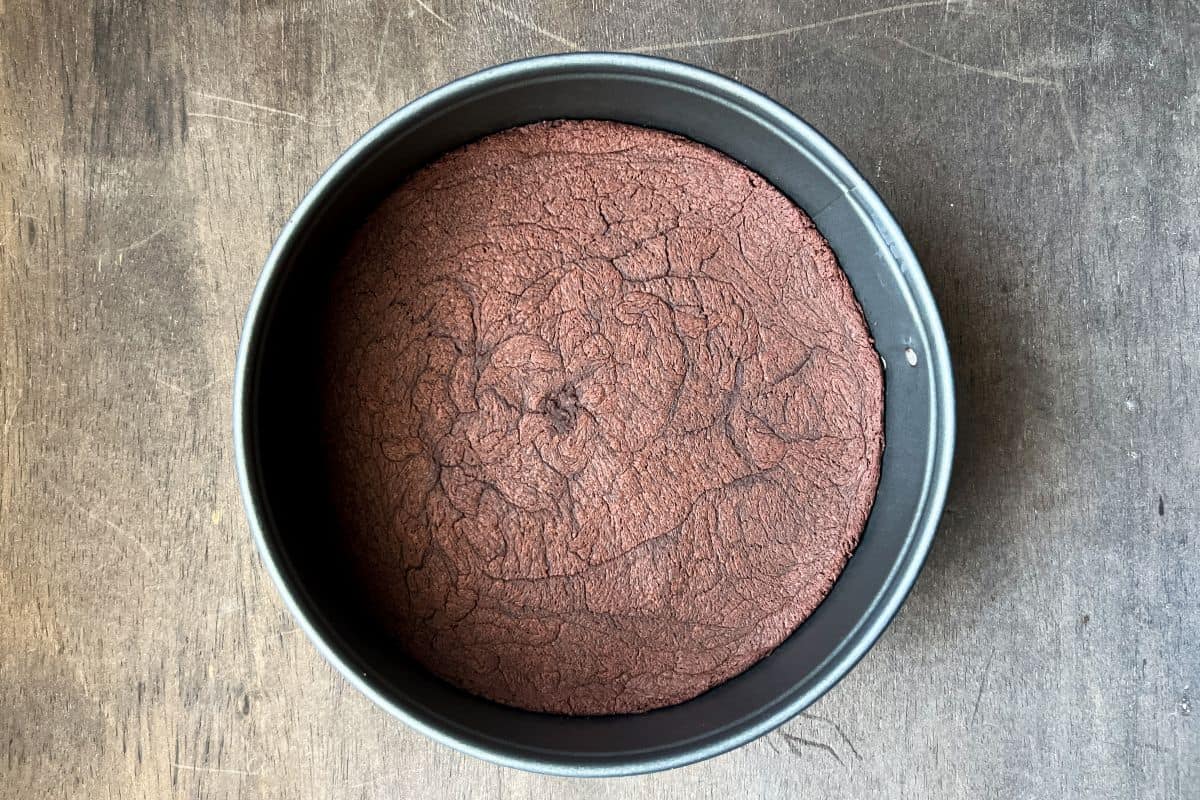 a brownie crust baked in a round springform pan