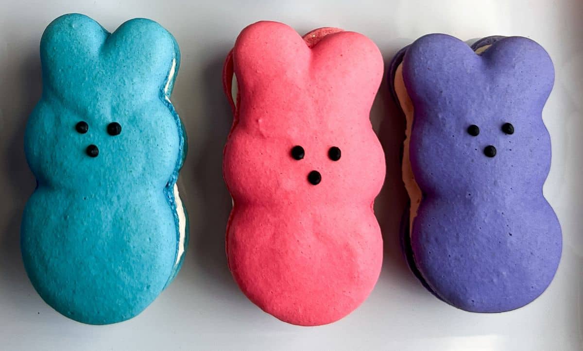 bunny peep macarons on a white plate