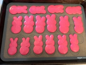 pink bunny peep macaron batter piped on a macaron mat