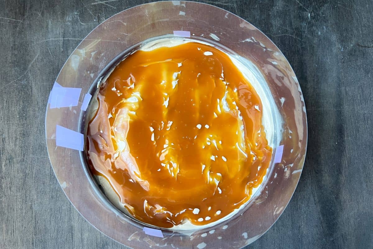 caramel sauce on top of coffee ice cream in a springform pan