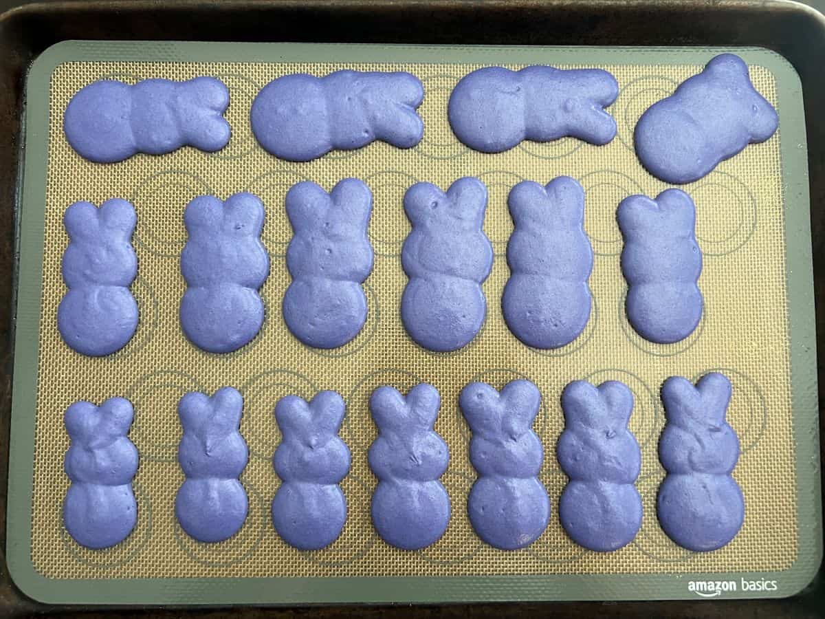 purple bunny peep macaron batter piped on a macaron mat