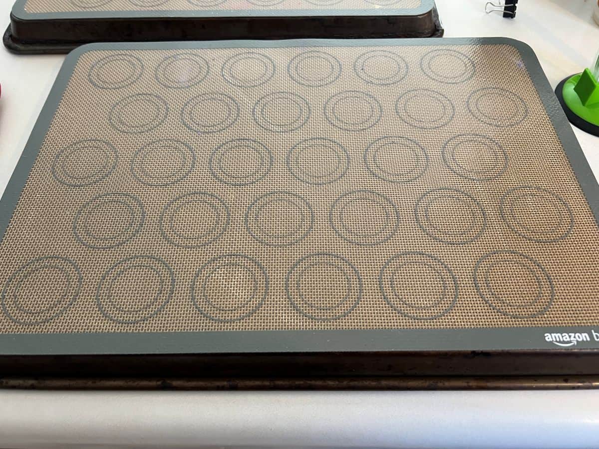 a baking sheet turned over with a macaron mat on top