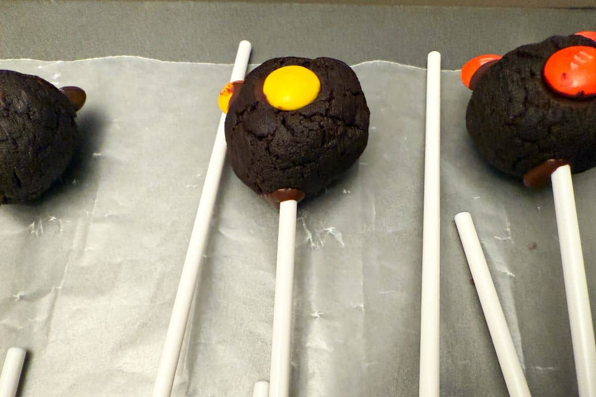 a cake pop on a stick on a piece of waxed paper
