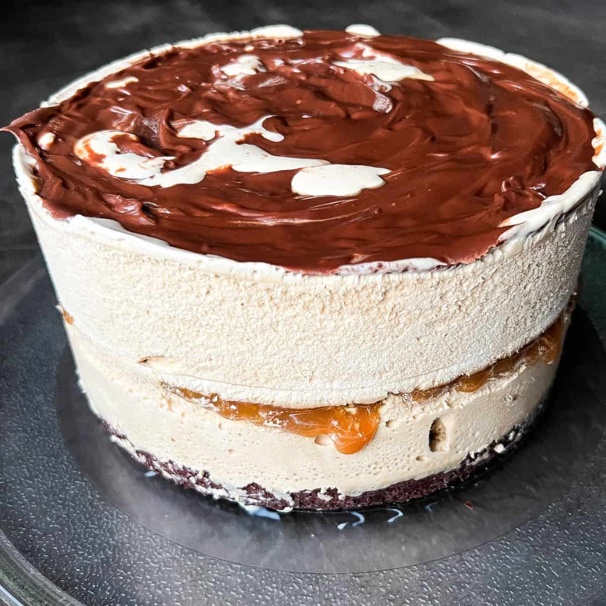 an assembled coffee ice cream cake before being frosted with whipped topping