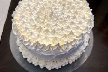 an ice cream cake decorated with whipped topping