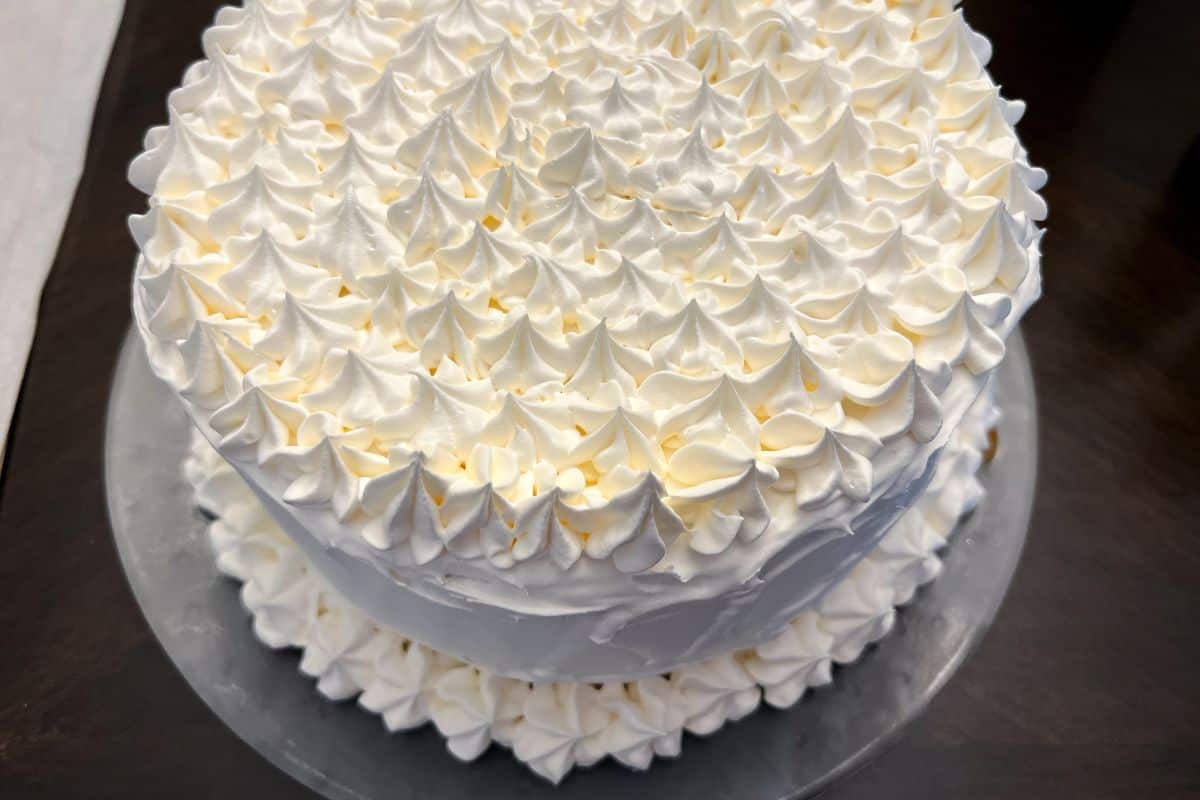 an ice cream cake decorated with whipped topping