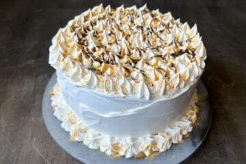 a caramel mocha ice cream cake with caramel and chocolate syrup drizzled on top