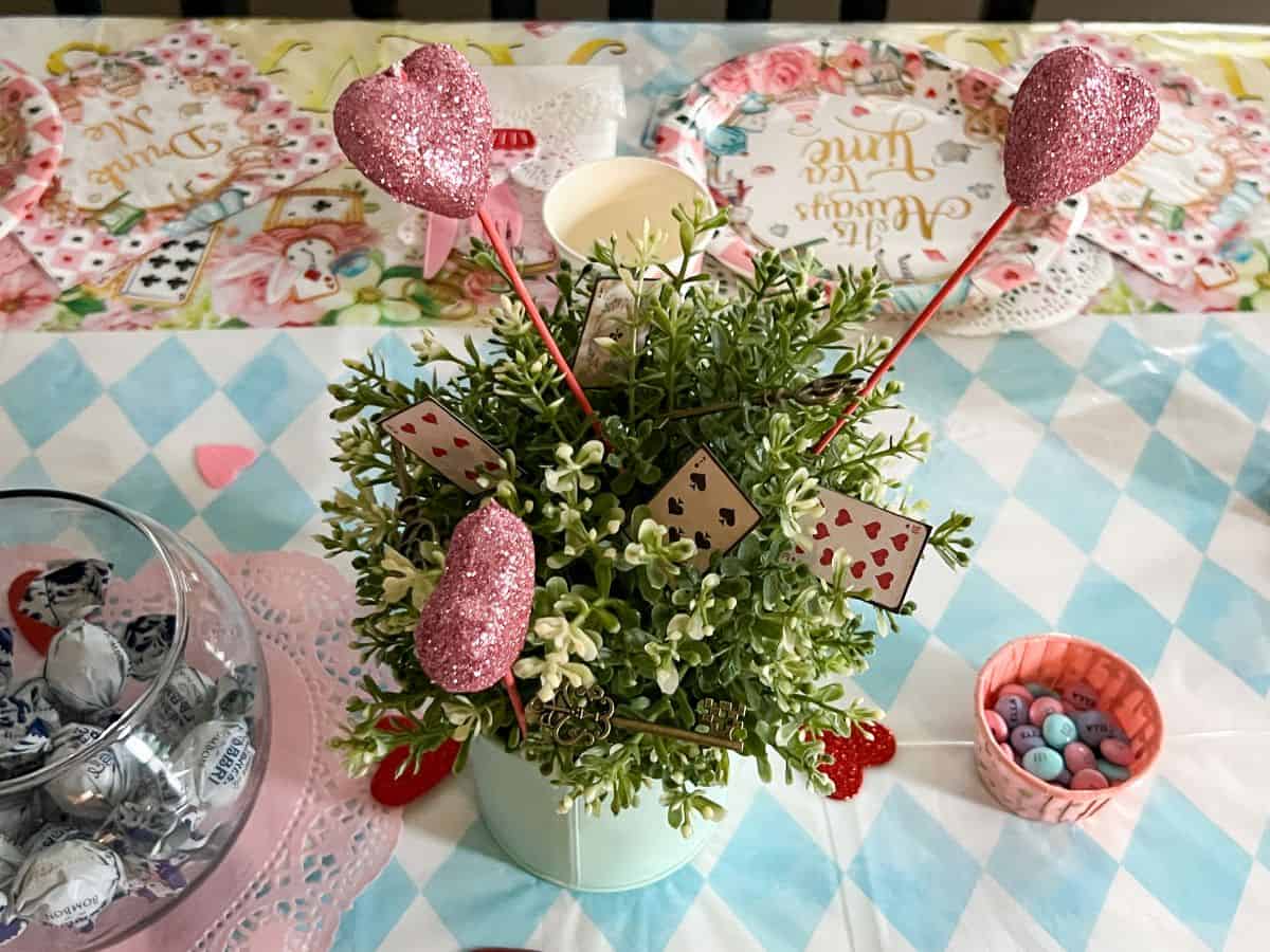 a faux plant with some heart sticks