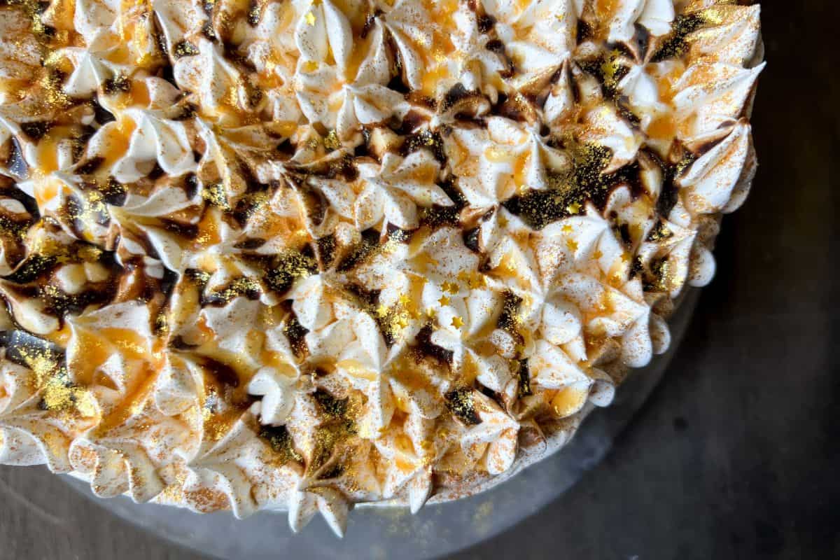 a caramel mocha ice cream cake with caramel and chocolate syrup drizzled on top
