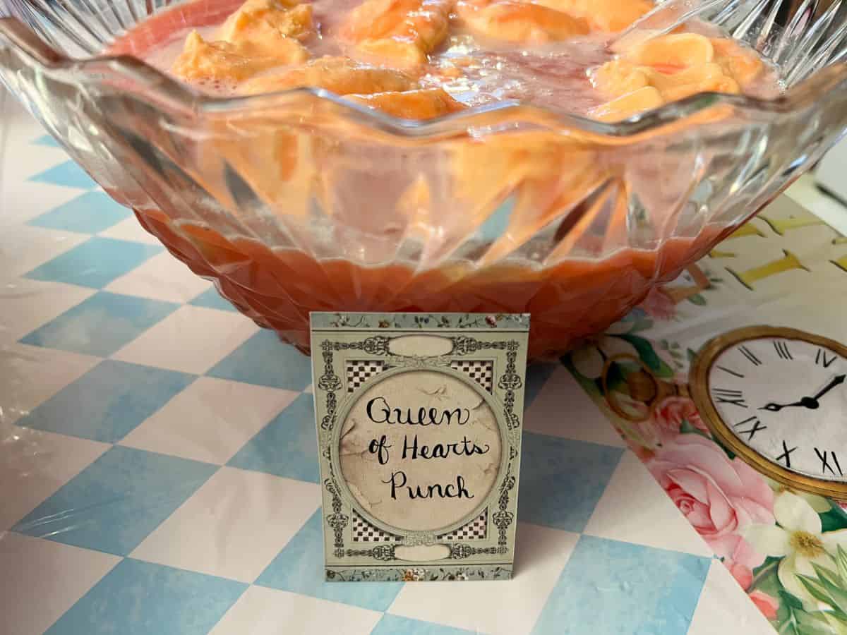 a bowl of pink citrus punch labeled "Queen of Hearts Punch"