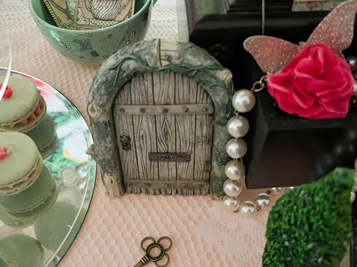 a little fairy door on a dessert table